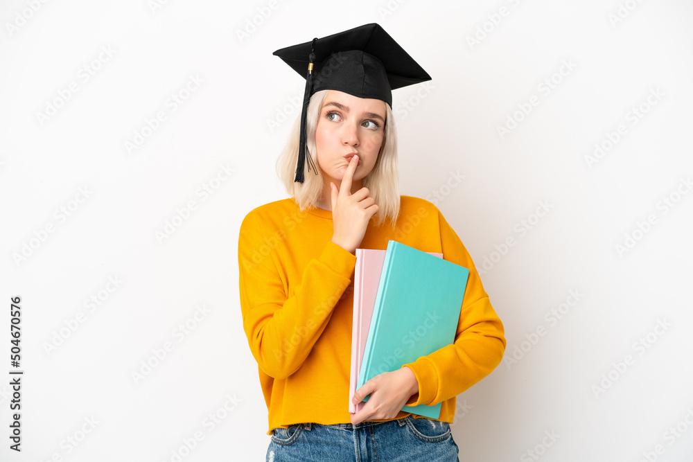 Young university caucasian woman graduate isolated on white background having doubts while looking up Young university caucasian woman graduate isolated on white background having doubts while looking up