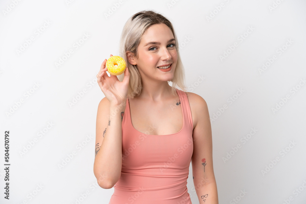 Young caucasian woman isolated on white background holding a donut and happy Young caucasian woman isolated on white background holding a donut and happy