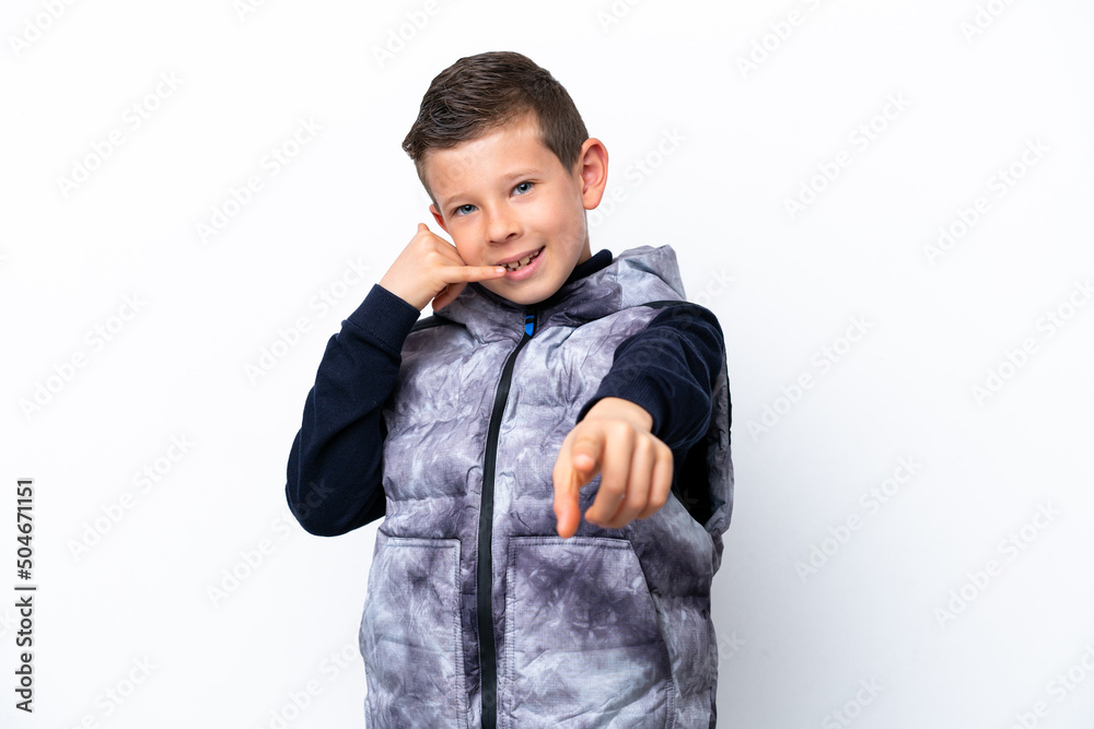 Little boy isolated on white background making phone gesture and pointing front Little boy isolated on white background making phone gesture and pointing front