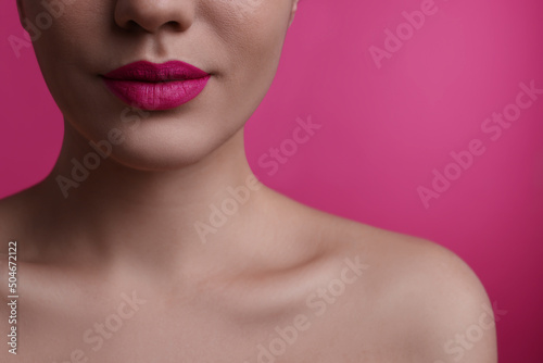 Closeup view of woman with beautiful full lips on pink background