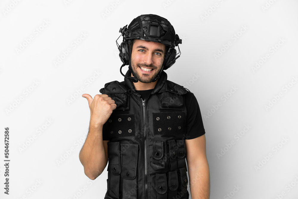 Young caucasian swat isolated on white background pointing to the side to present a product Young caucasian swat isolated on white background pointing to the side to present a product