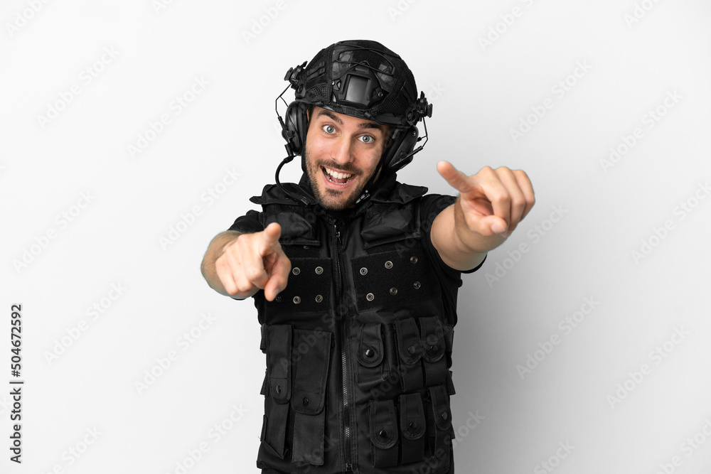Young caucasian swat isolated on white background points finger at you while smiling Young caucasian swat isolated on white background points finger at you while smiling