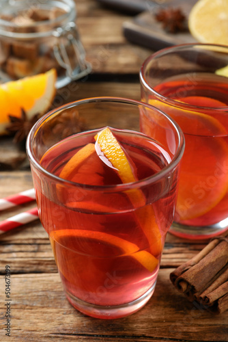 Aromatic punch drink and ingredients on wooden table