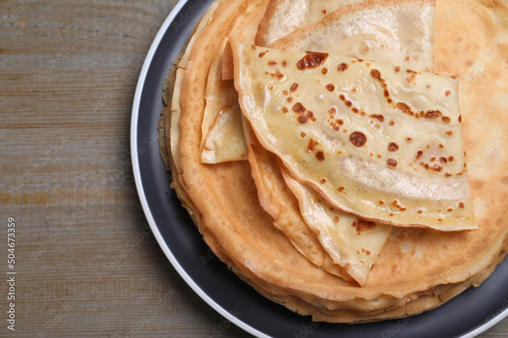 Stack of delicious crepes on grey wooden table, top view Stack of delicious crepes on grey wooden table, top view
