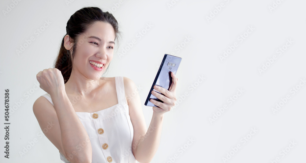 Asian beautiful woman are holding and looking smartphone and smiling with happiness for a shopping online. Asian beautiful woman are holding and looking smartphone and smiling with happiness for a shopping online.