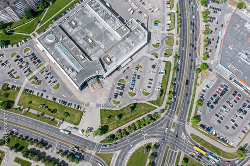 aerial view of city roads intersection in residential area near shopping center