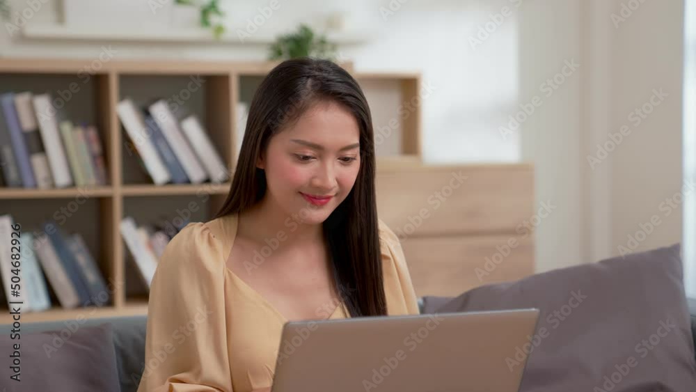 Young adult business woman typing on laptop computer working in internet, Happy young Asian girl relax sitting on desk do job in internet. Business technologies concept. Young adult business woman typing on laptop computer working in internet, Happy young Asian girl relax sitting on desk do job in internet. Business technologies concept.