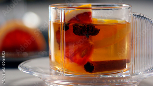 Mulled Wine in Glass Coffee Cup, Blood Orange in Background