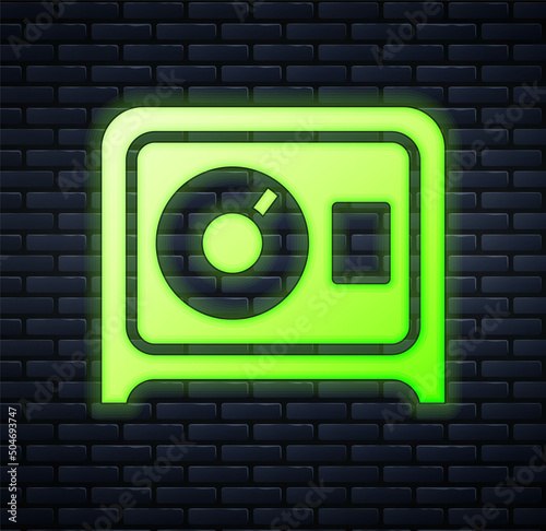 Glowing neon Safe icon isolated on brick wall background. The door safe a bank vault with a combination lock. Reliable Data Protection. Vector