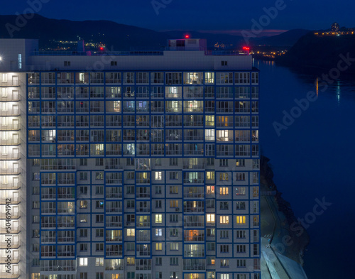 Siberian city of Krasnoyarsk. Night view from above on the Yenisei River. High-rise new residential building photo