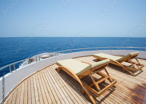 View from bow deck of luxury yacht with sunbeds
