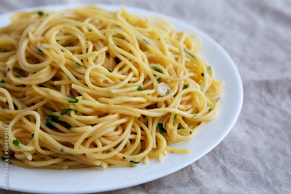 Homemade Spaghetti with Garlic and Oil Pasta on a Plate, low angle view. Close-up. Homemade Spaghetti with Garlic and Oil Pasta on a Plate, low angle view. Close-up.