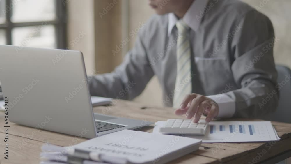 Close up slow motion of business man’s hands is calculating, checking and writing on paper that shows chat of accounting statistics on the table. Soft mood and soft focus. Close up slow motion of business man’s hands is calculating, checking and writing on paper that shows chat of accounting statistics on the table. Soft mood and soft focus.