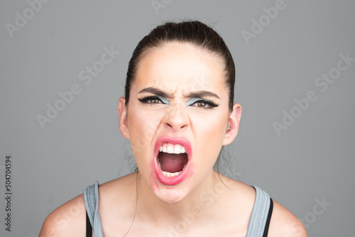 Screaming, hate, rage. Pensive woman feeling furious mad and crazy stress. Sad and angry face. Shouting mouth, screaming face.