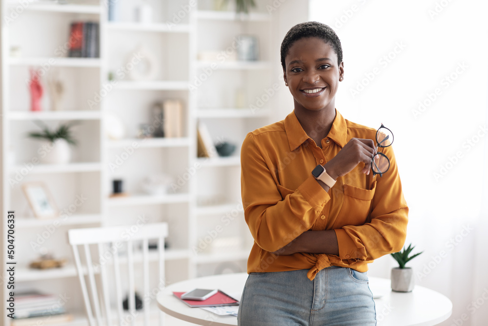 Happy successful young black woman posing at office Happy successful young black woman posing at office
