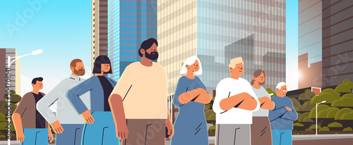 mix race people group in casual clothes standing together outdoor horizontal cityscape background