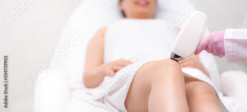 Obraz na płótnie Banner Diode laser hair removal, Beautician removes hair on beautiful female legs, Hair removal for smooth skin, laser procedure at beauty studio or clinic, Body care epilation treatment