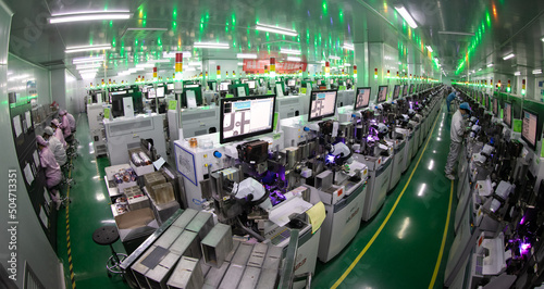 Photography Jiujiang, China - May 14, 2022: Workers operate intelligent machines to produce LED product orders at the production workshop of Jiangxi Lanke Semiconductor Co