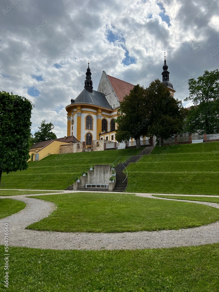 catholic old church against the background of the sky and spring nature