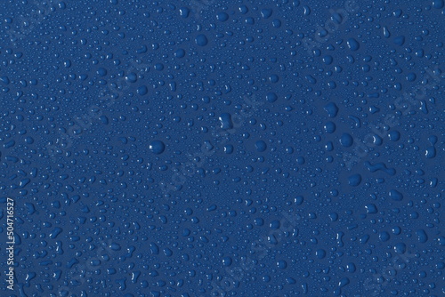 Water droplets on a colored texture. Decorative texture with water drops.