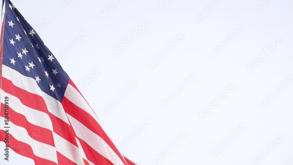 American flag waving in wind, USA. National symbol waves in breeze on