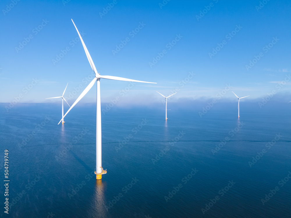 Offshore Windmill farm in the ocean Westermeerwind park, windmills isolated at sea on a beautiful bright day Netherlands Flevoland Noordoostpolder. Huge windmill turbines - obrazy, fototapety, plakaty 