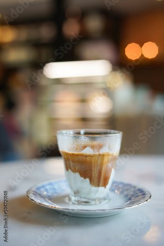 cup of coffee with milk  dirty coffee.  A glass of espresso shot mixed with cold fresh milk in cafe