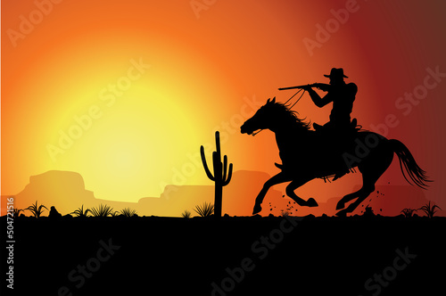 Silhouette cowboy riding a horse carrying a gun at sunset.