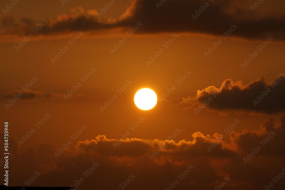 Bright orange Sunrise illuminating the clouds