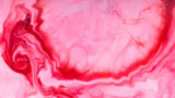 Pink liquid abstract surface. Colorful spots on a water surface. Fluid art texture with pink stains on the liquid