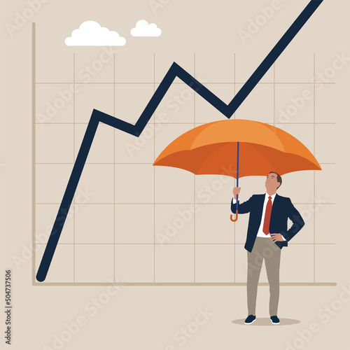 Businessman holding umbrella protect graph down. Protection from economic crisis