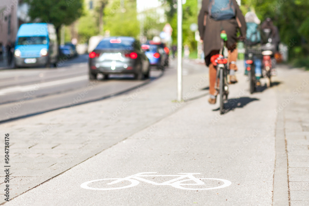 Bicycle sign on bike path in Europe. Bicyclist in bike lane on Street
