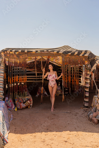 Valokuva Woman walking out of a Bedouin tent
