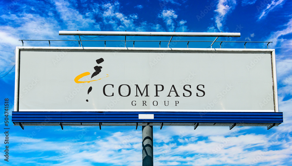 Advertisement billboard displaying logo of Compass Group Stock Photo