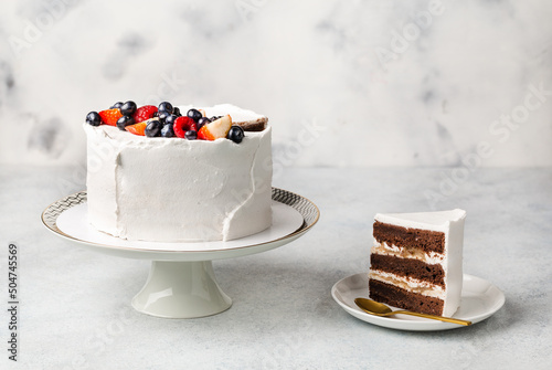 festive white cake decorated with berries on a light background. Sweets concept for Mothers Day, Wedding day, Valentines Day