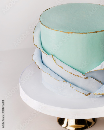 festive big light  blue cake on a gray background. Sweets concept . Macro detail