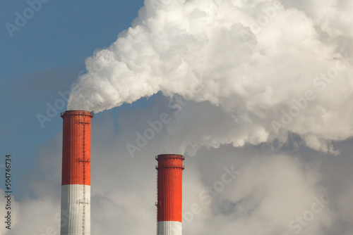 Fotografija White puffs of smoke from the chimneys of a thermal power plant