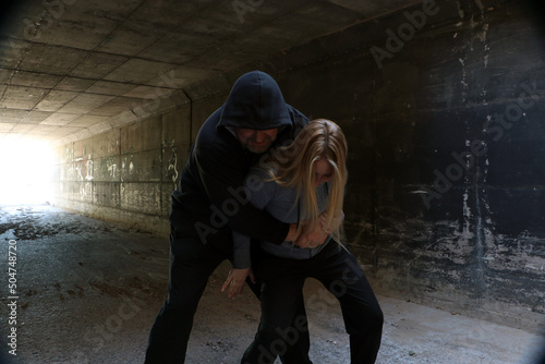 Young female defending herself from an attack	 photo