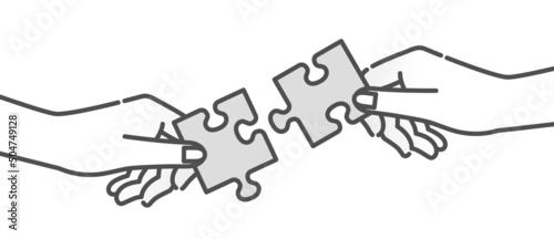 パズルのピースを持つ手。協力、協働の比喩。
