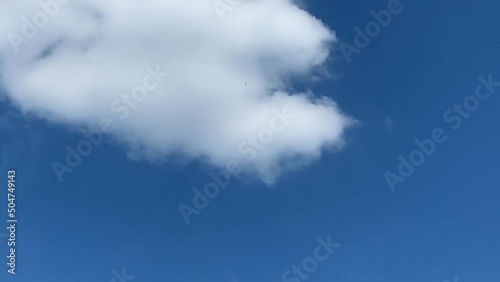 Airplane doing aerobatics in the blue sky at an airshow