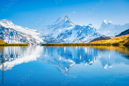 High mountains and reflection on the surface of the lake. Mountain valley wit...