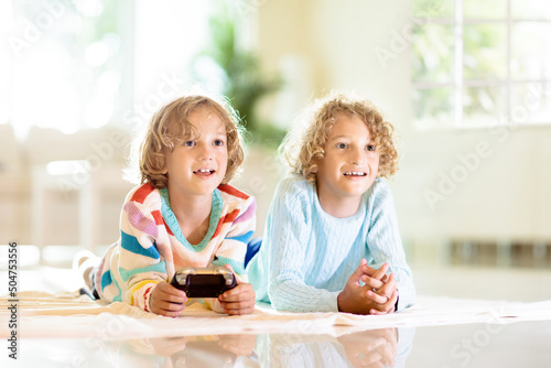 Kids play video game. Children with controller.