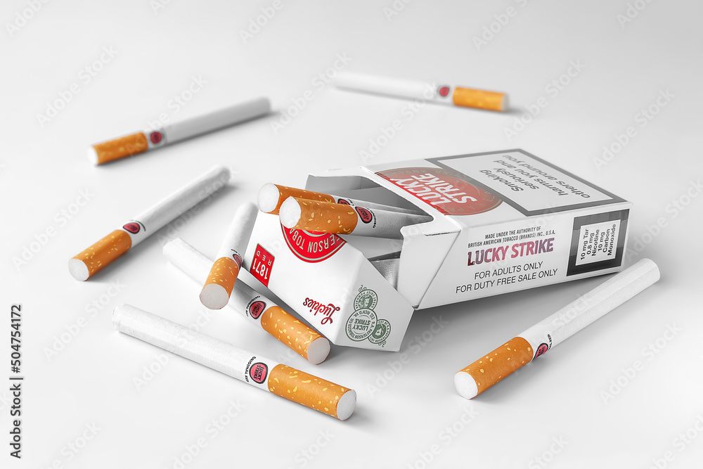 Pack of Lucky Strike cigarettes. Lucky Strike cigarettes are scattered ...