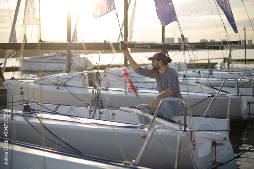Preparation for the regatta at the yachting school at the marina with sailing yachts.