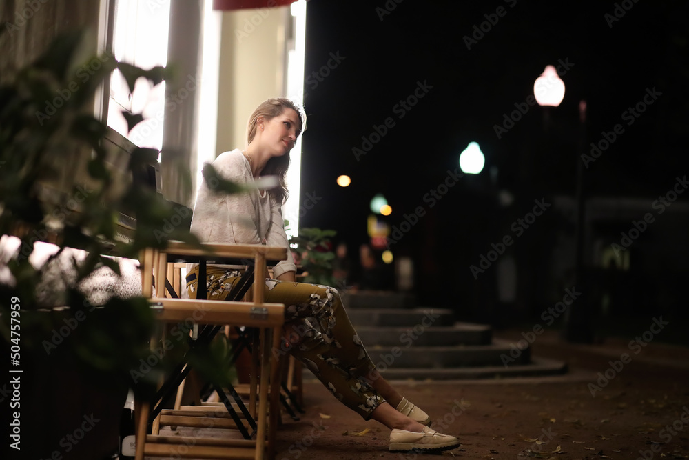 Girl sitting in a cafe at night Girl sitting in a cafe at night