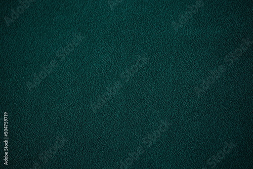 Delicate dark green thin fabric, emerald material chiffon blank background photo