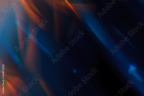 Colorful light leak on black background, abstract design with optical lens flare shot on a long lens.