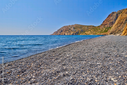 A hot sunny summer day in the Greek islands.The Mavra Volia (Black Pebbles) beach at Chios island, Greece. photo