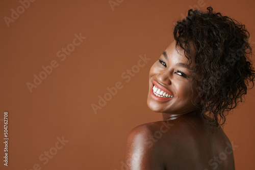 Studio portrait of joyful happy young Black woman looking at camera