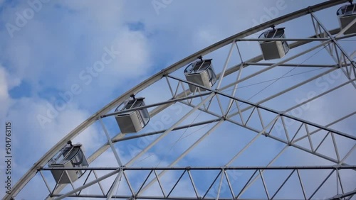 Ferris wheel on a background of blue sky and clouds. Entertainment park. Close-up